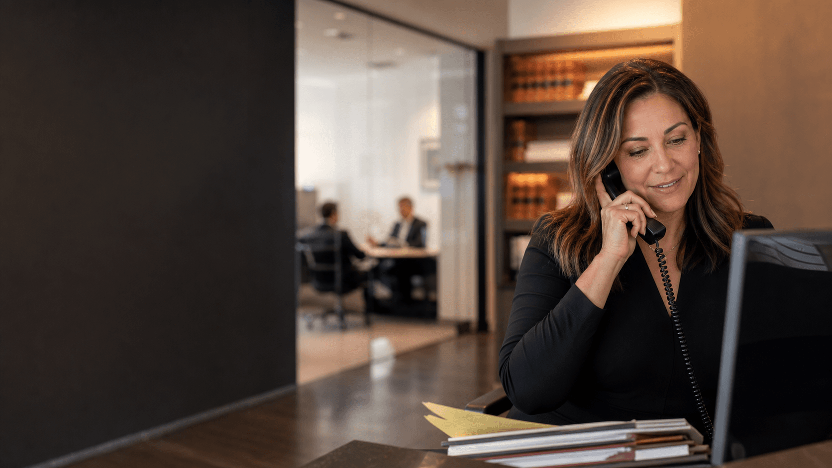 Law firm office manager reviewing calls at reception